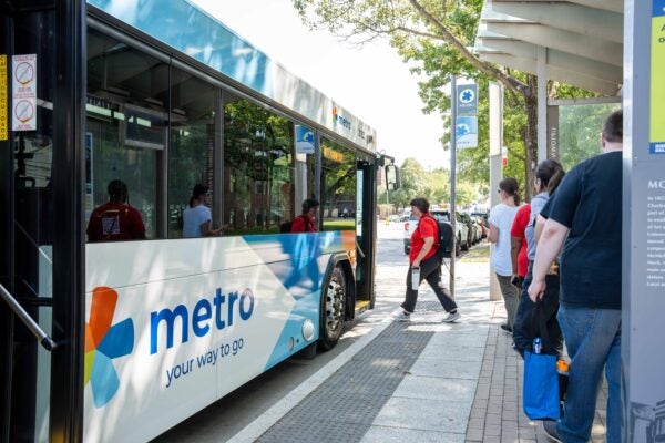 University students getting on a Metro bus